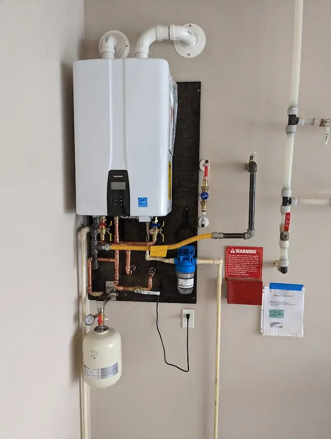 Professional plumber installing copper piping in a Darien home